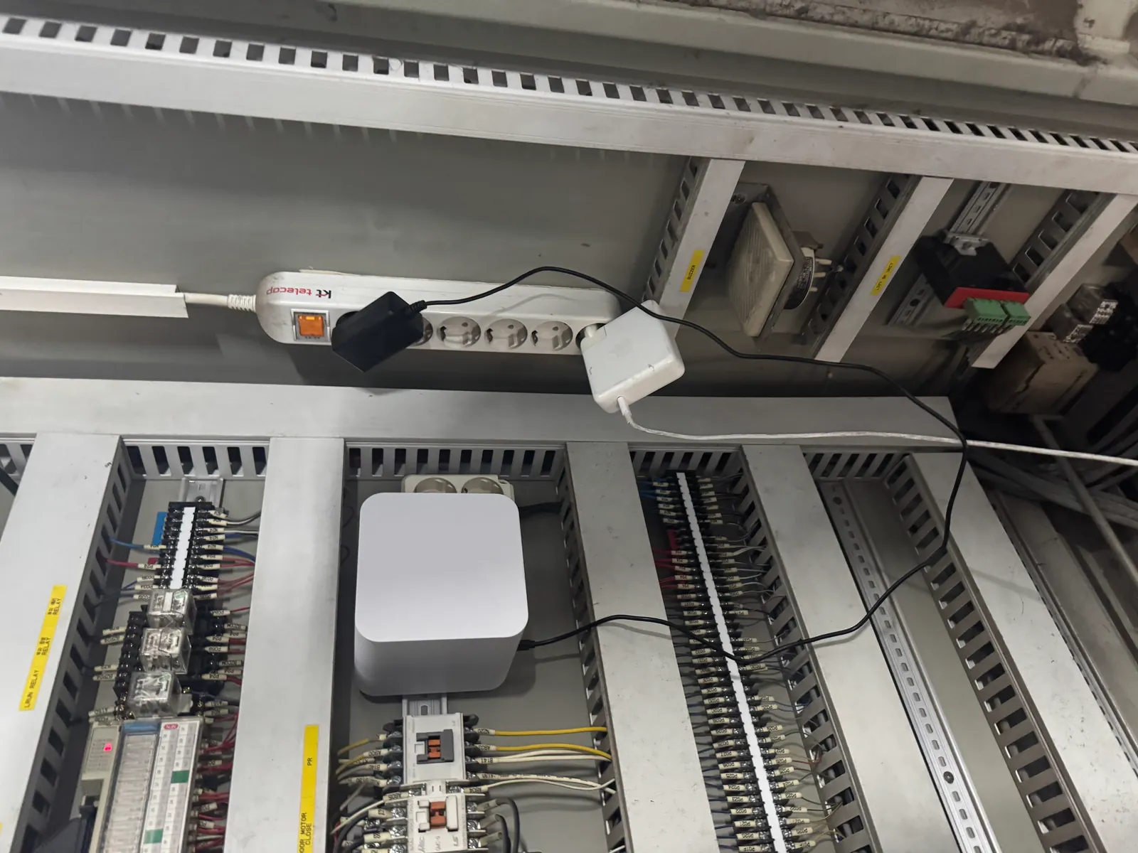 A FLUX Gateway installed inside a live parking-tower control cabinet alongside existing PLCs and relays